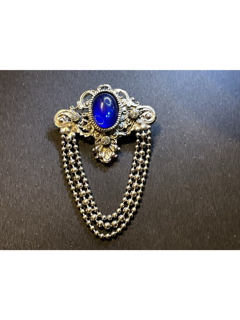 Silver Tone Filigree Blue Cabochon and Chain Dangles Brooch